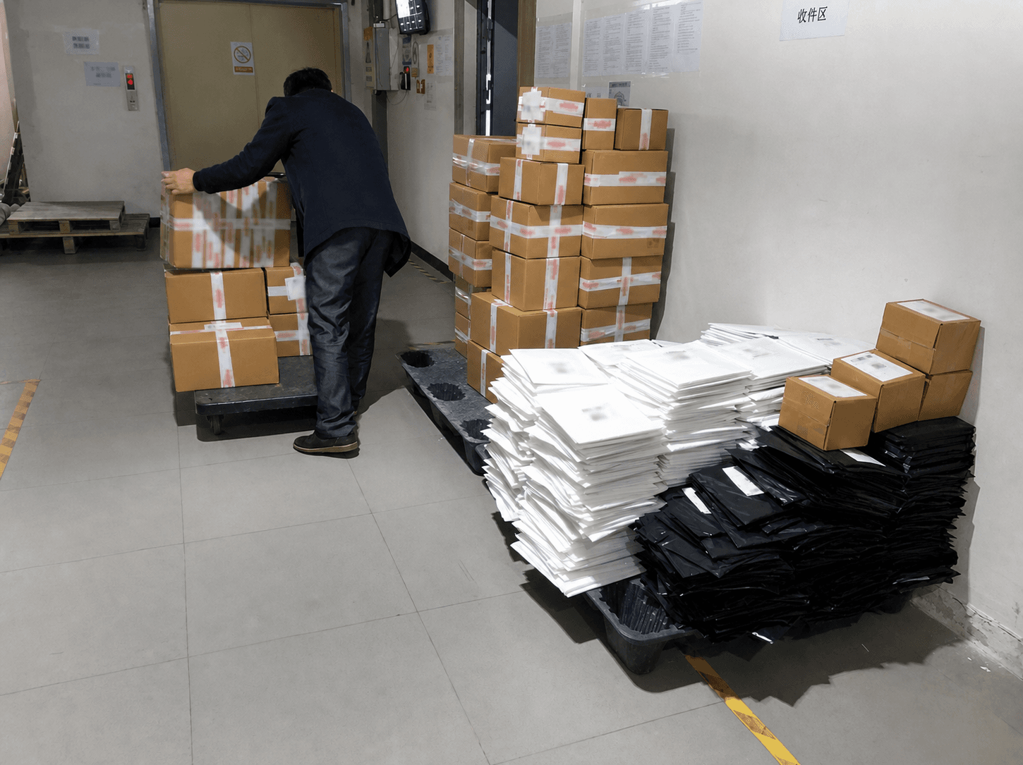 Warehouse worker moving prepared parcels for dispatch